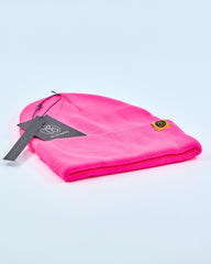 Fuschia pink beanie on a light gray background
