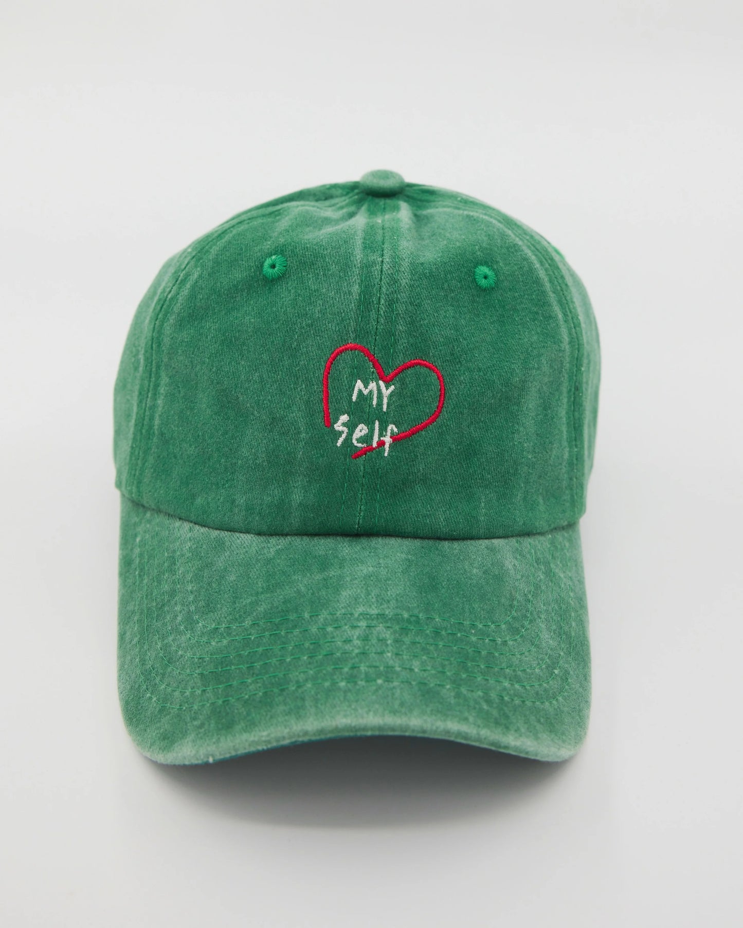 front view of green love myself washed cap