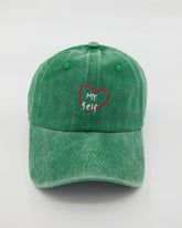 front view of green love myself washed cap
