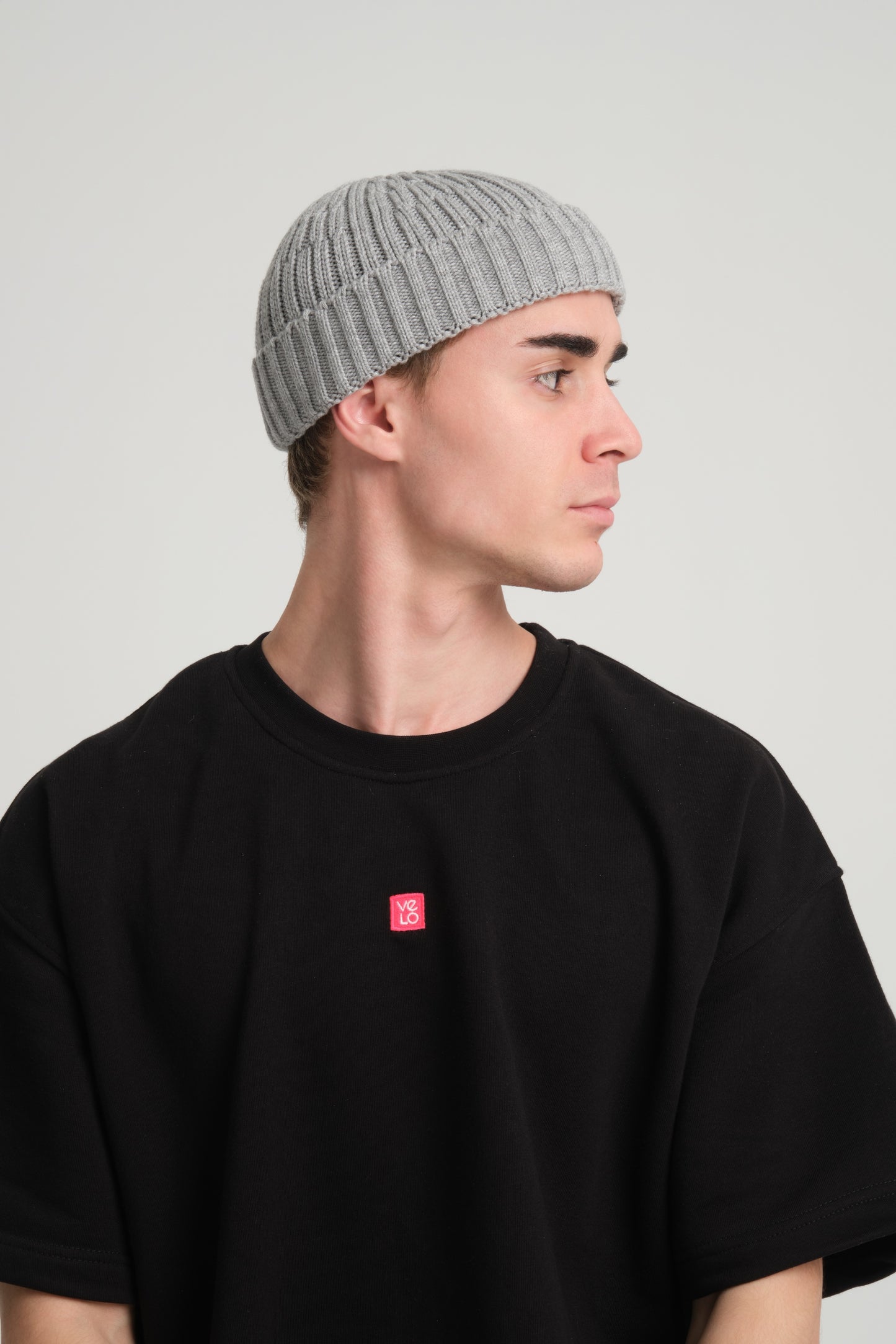 side view of a man wearing Grey Fisherman Beanie
