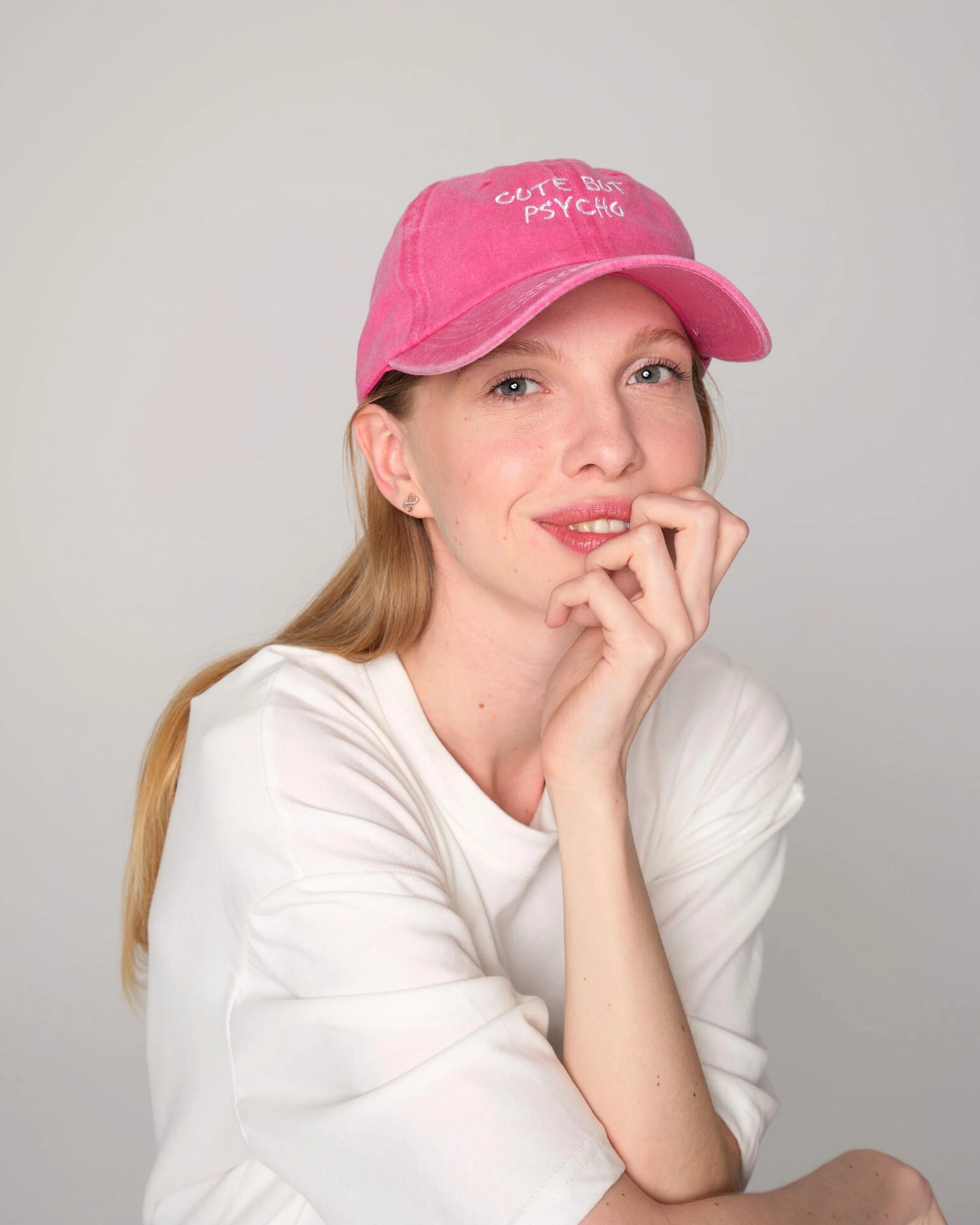 woman wearing Cute But Psycho Hot Pink Washed Cap Hat
