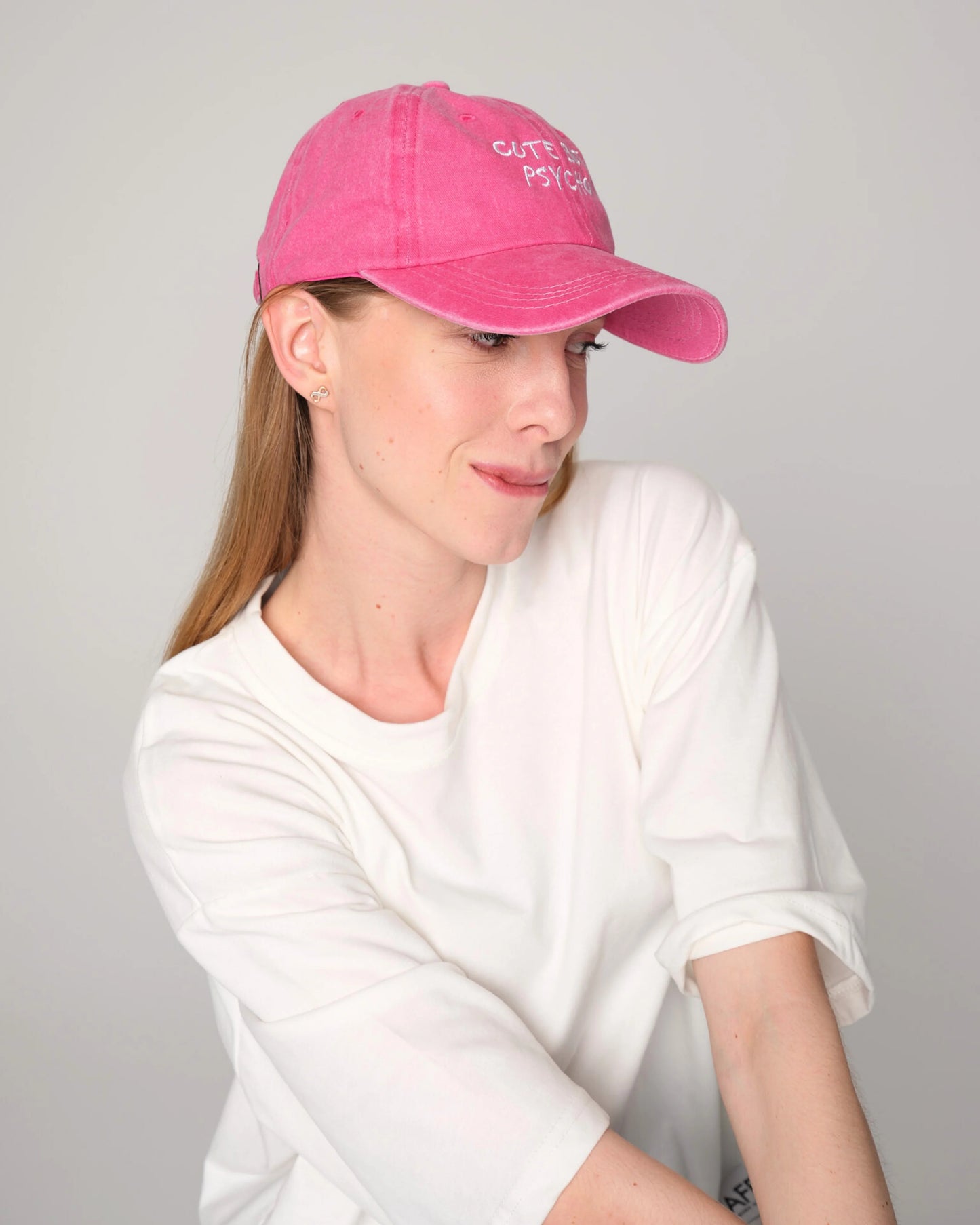 woman wearing Cute But Psycho Hot Pink Washed Cap