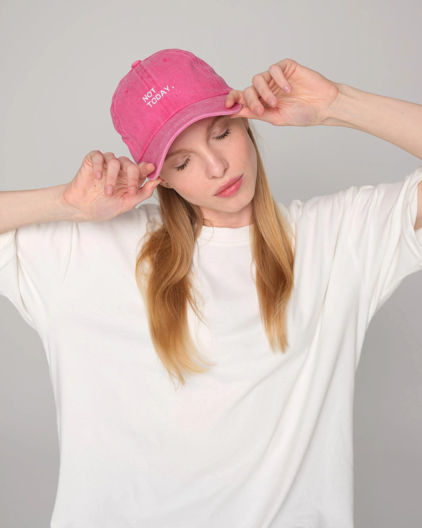woman holding Hot Pink Washed Cap with Not Today embroidered in white