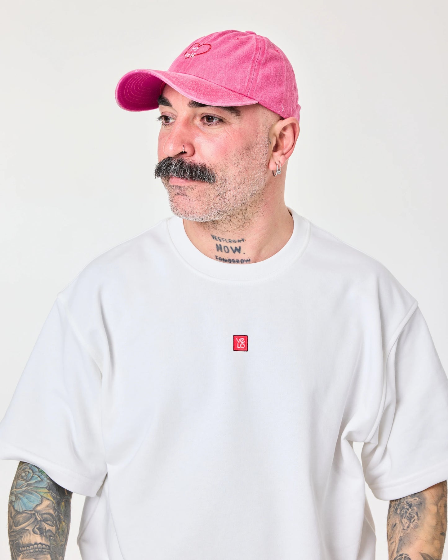 man wearing hot pink washed cap with love myself embroidered in white