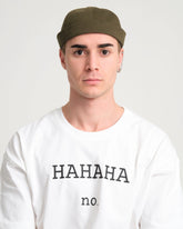 man wearing khaki docker cap