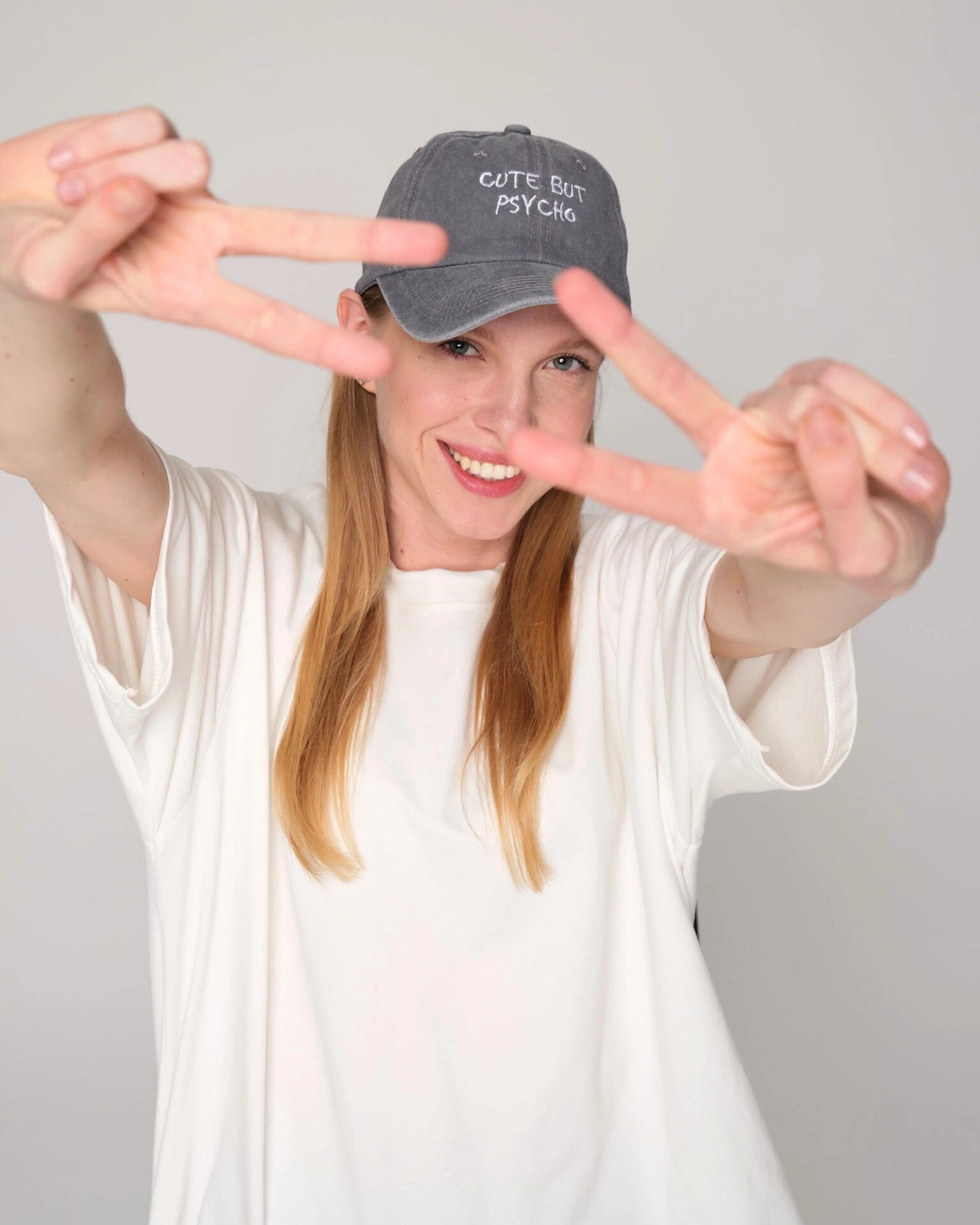 woman wearing Cute But Psycho Light Gray Washed Cap