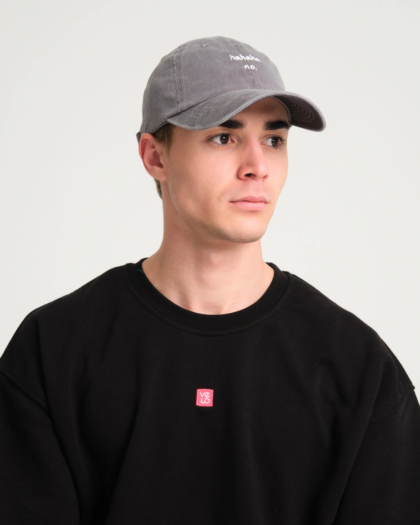 man is wearing light gray hahaha no washed cap