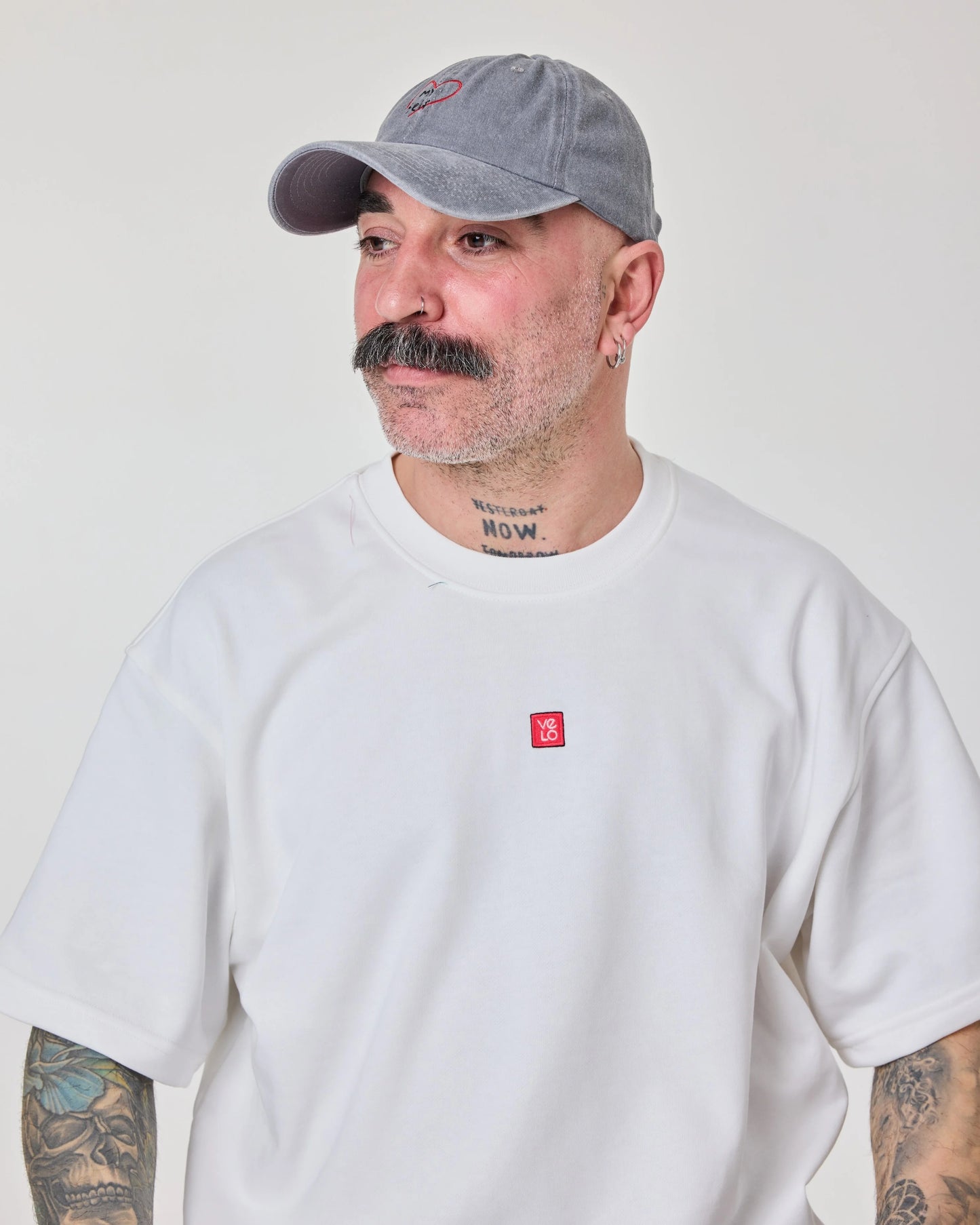 man wearing light gray washed cap with love myself embroidered in white