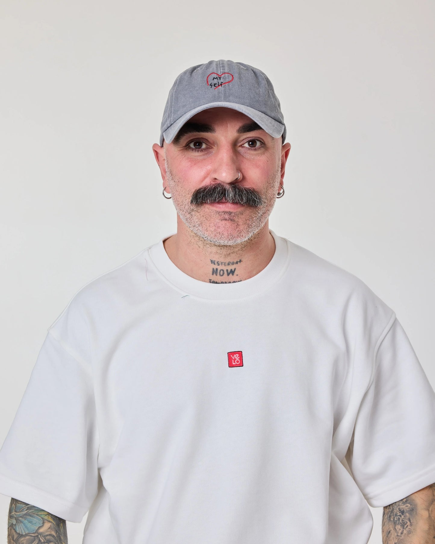 man wearing Light Gray Washed Cap with Love Myself embroidered in white