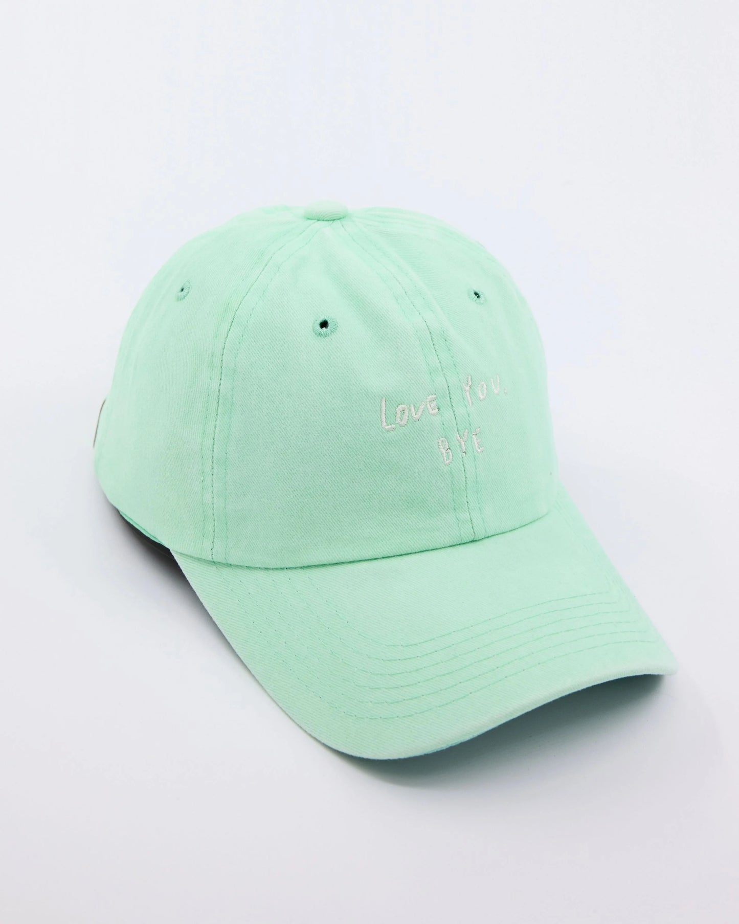 side view of Light Green Washed Cap with Love You Bye embroidered in white