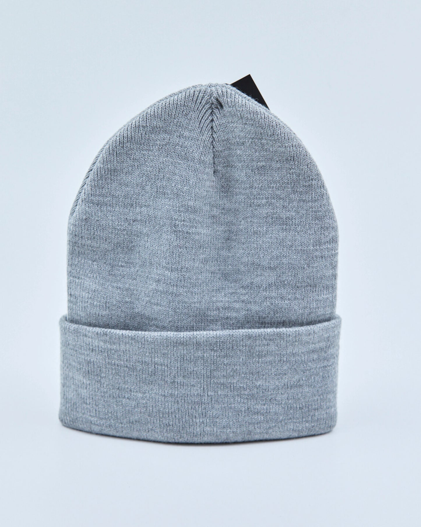 Light gray beanie on a light blue background
