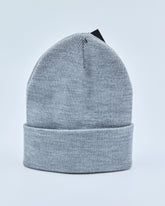 Light gray beanie on a light blue background