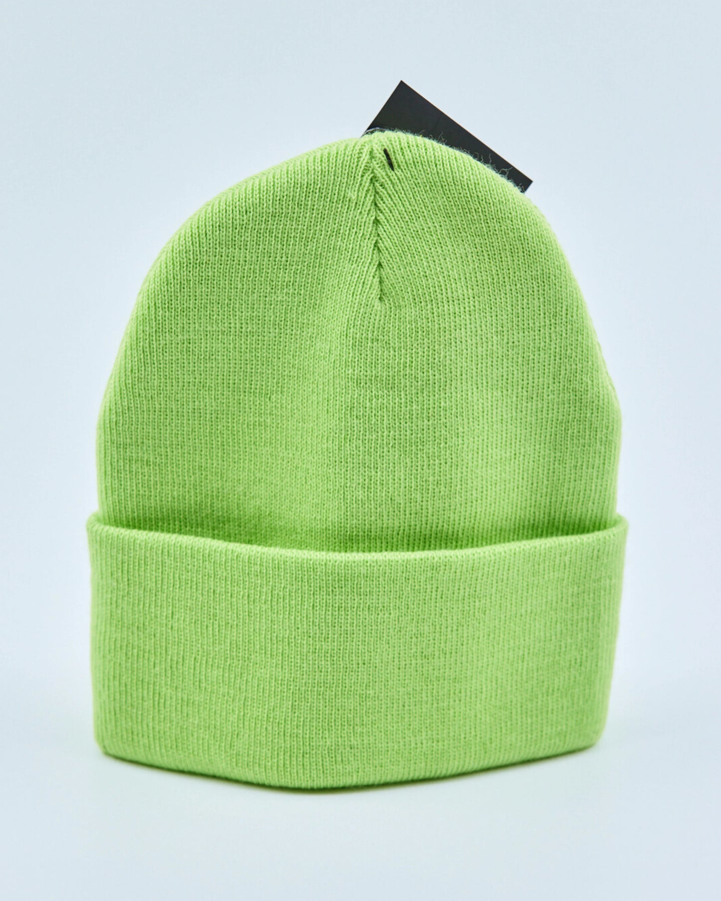 Light lime green beanie on a light gray background
