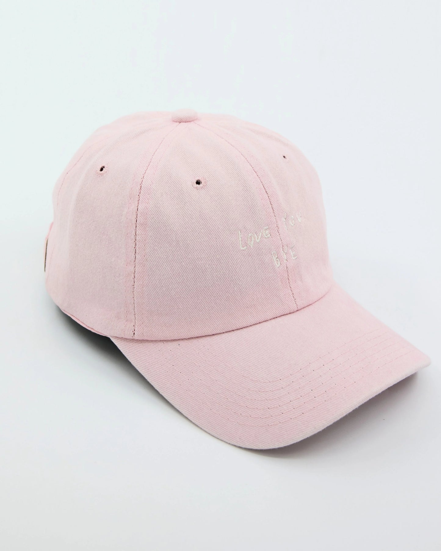 side view of Light Pink Washed Cap with Love You Bye embroidered in white