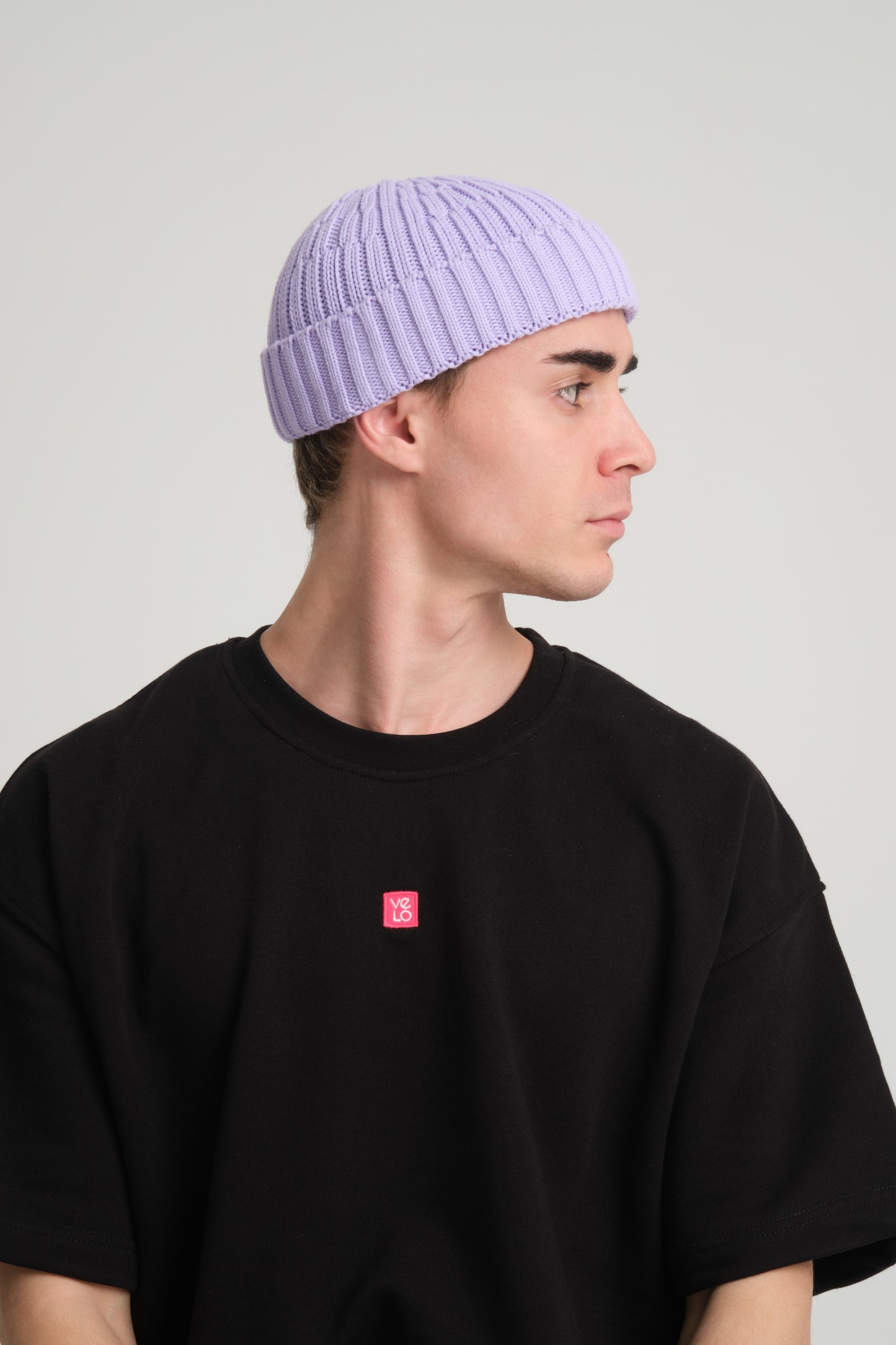 side view of a man wearing Lilac Fisherman Beanie