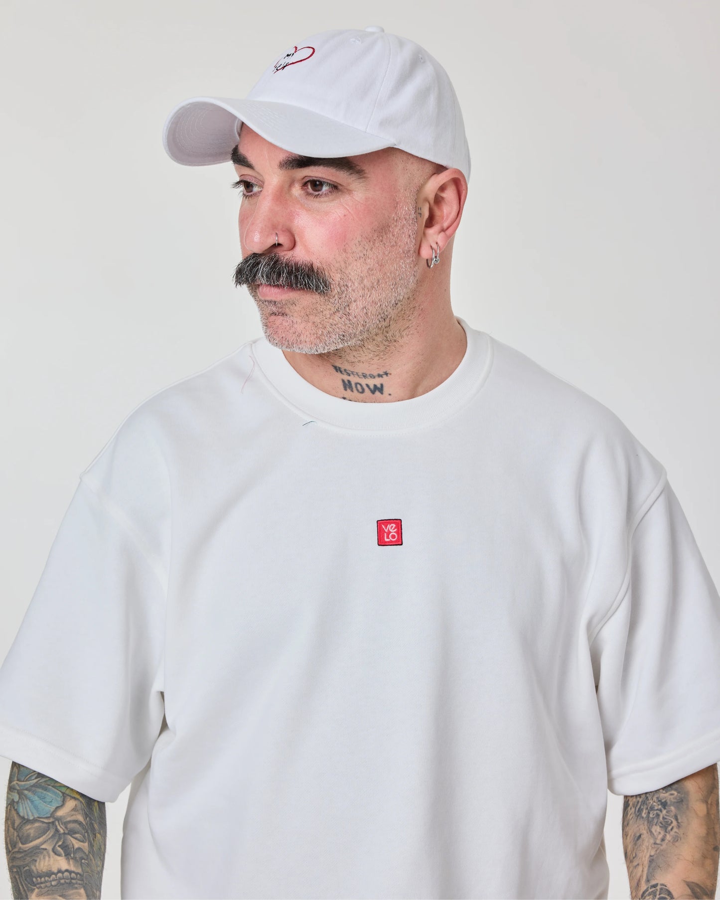side look of male model wearing love myself embroidered white washed cap