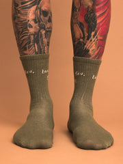 khakisocks worn with tattoos on a beige background