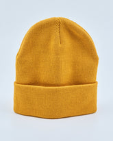 Mustard yellow beanie on a light gray background