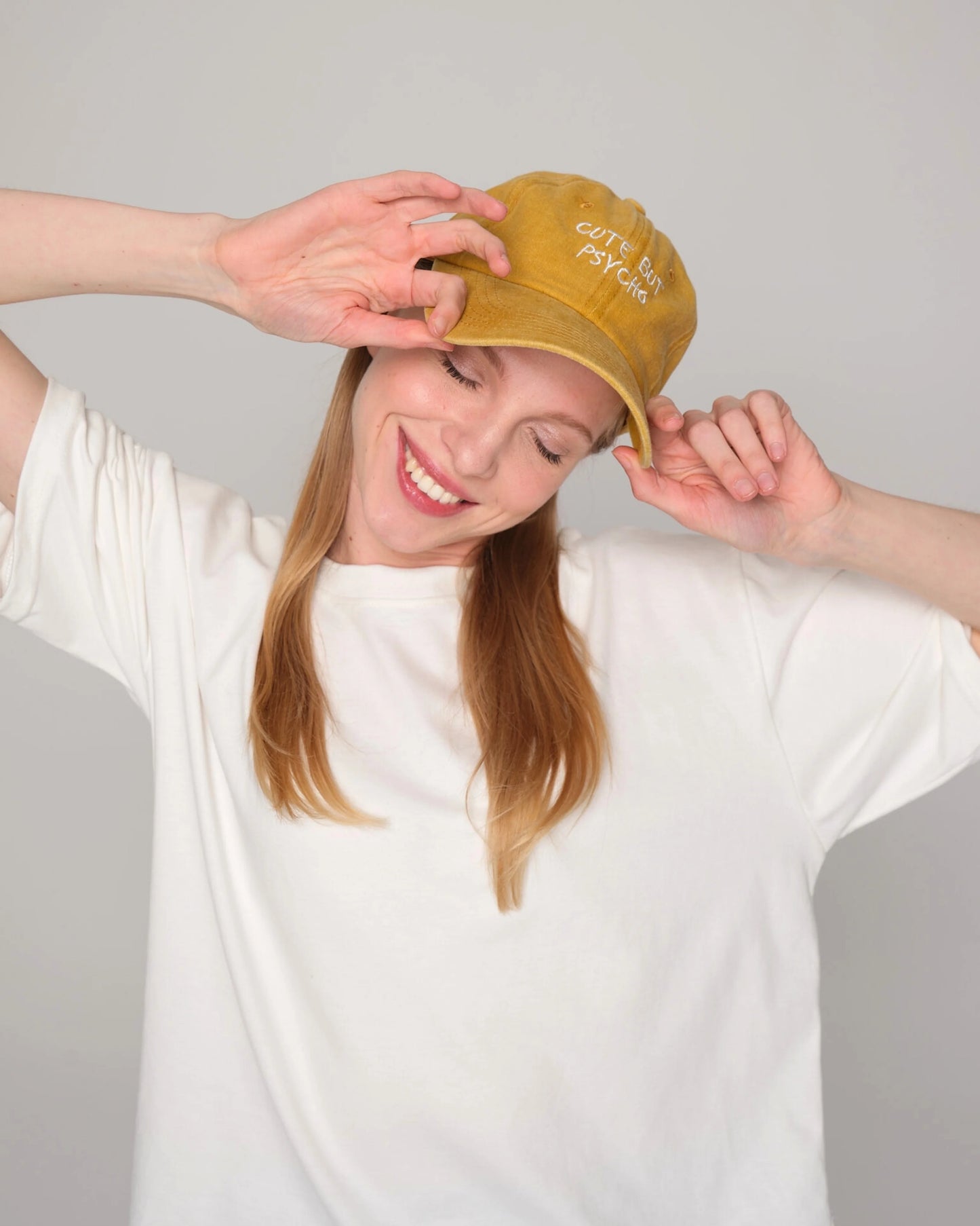 woman wearing Cute But Psycho Mustard Washed Cap