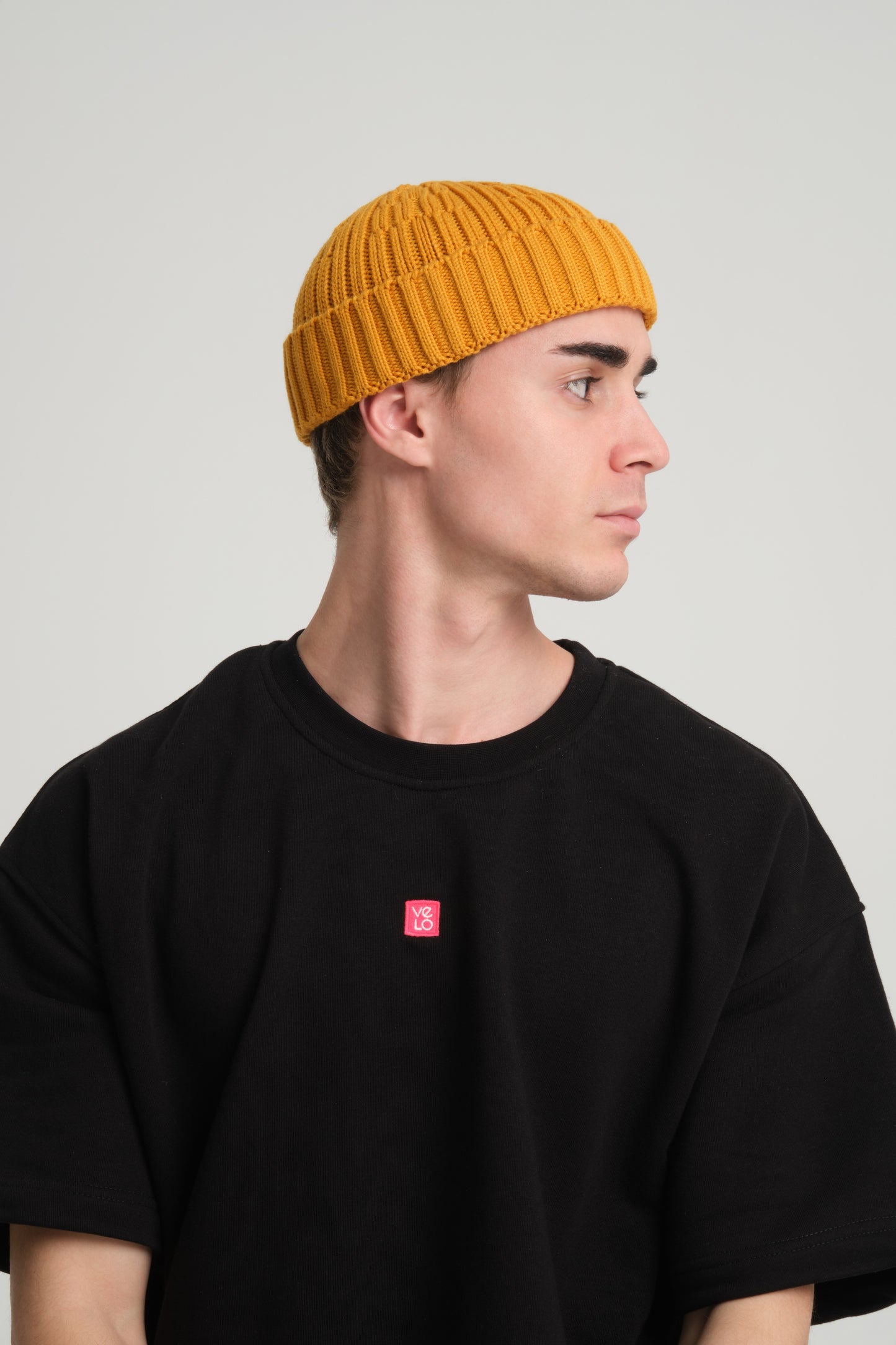 side view of a man wearing Mustard Fisherman Beanie