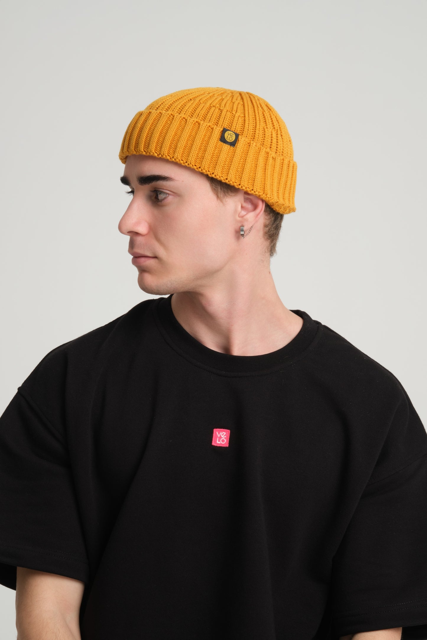 side view of a man wearing Mustard Fisherman Beanie