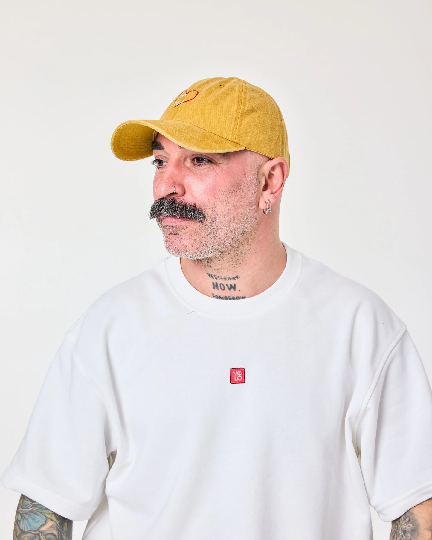 side view of man wearing Love Myself Mustard Washed Cap