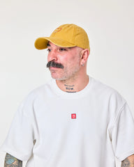 side view of man wearing Love Myself Mustard Washed Cap