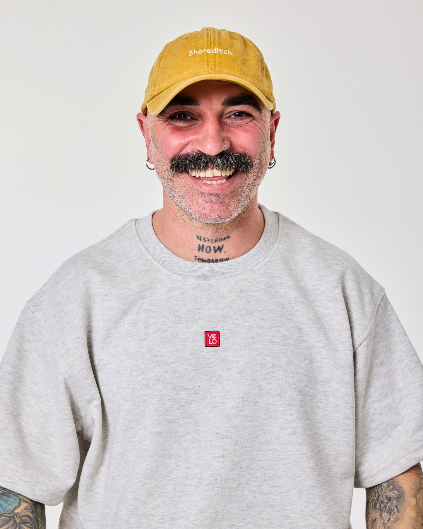 front view of a man wearing Shoreditch Mustard Washed Cap
