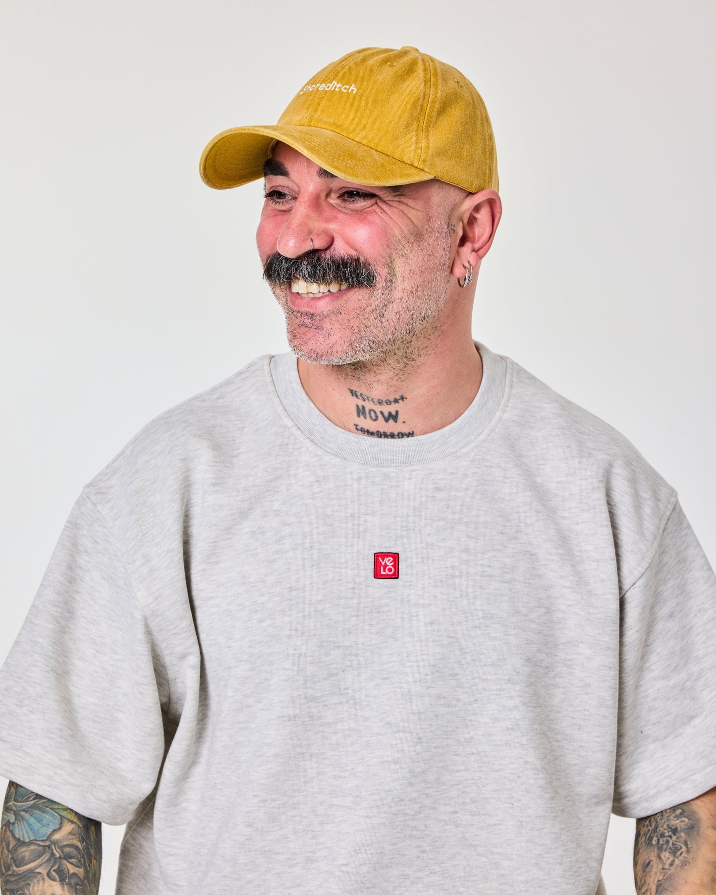 side view of a man wearing Shoreditch Mustard Washed Cap