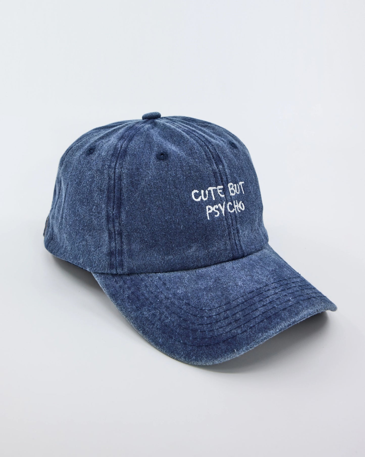 side view of Cute But Psycho Navy Blue Washed Cap