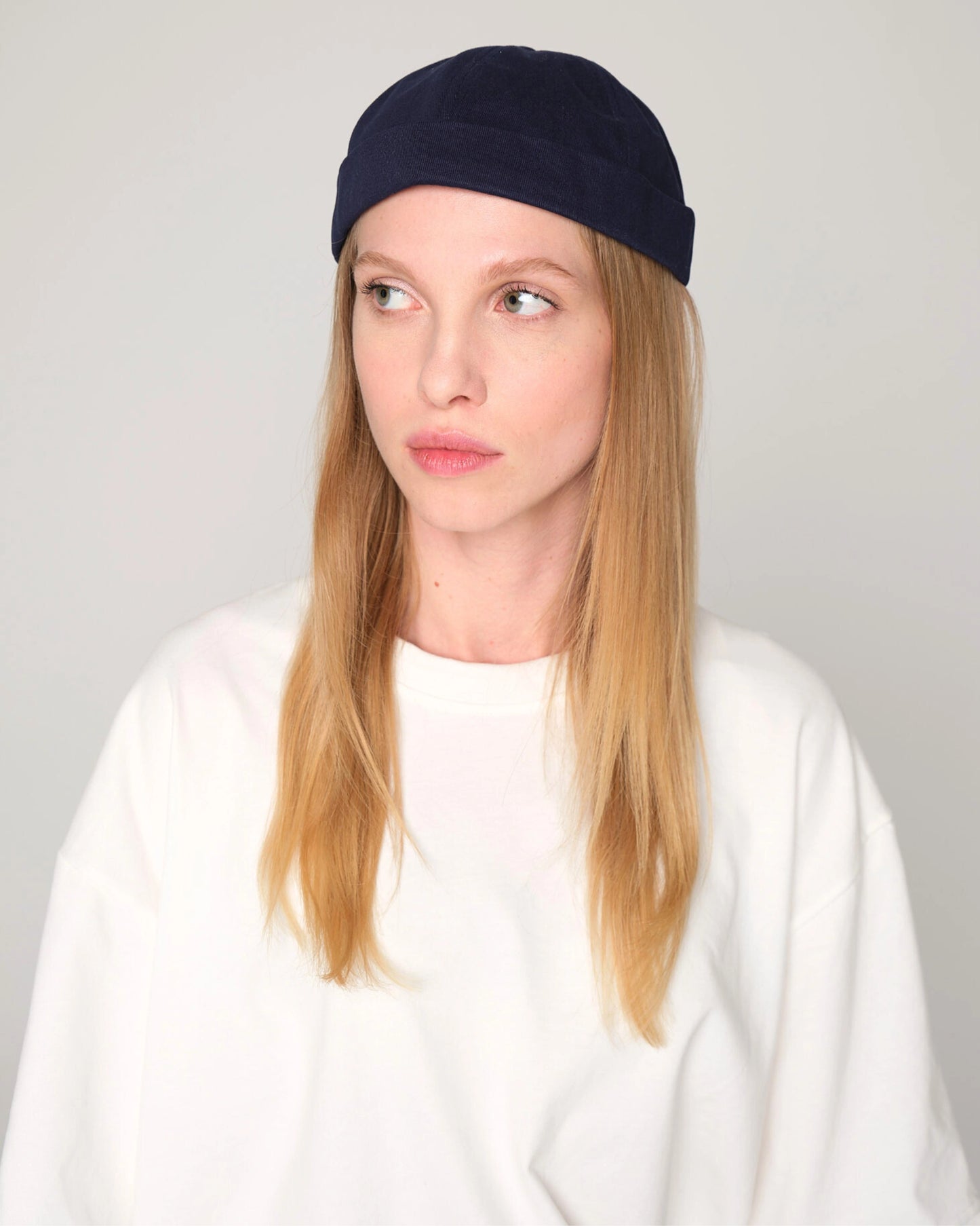 woman wearing navy blue docker hat