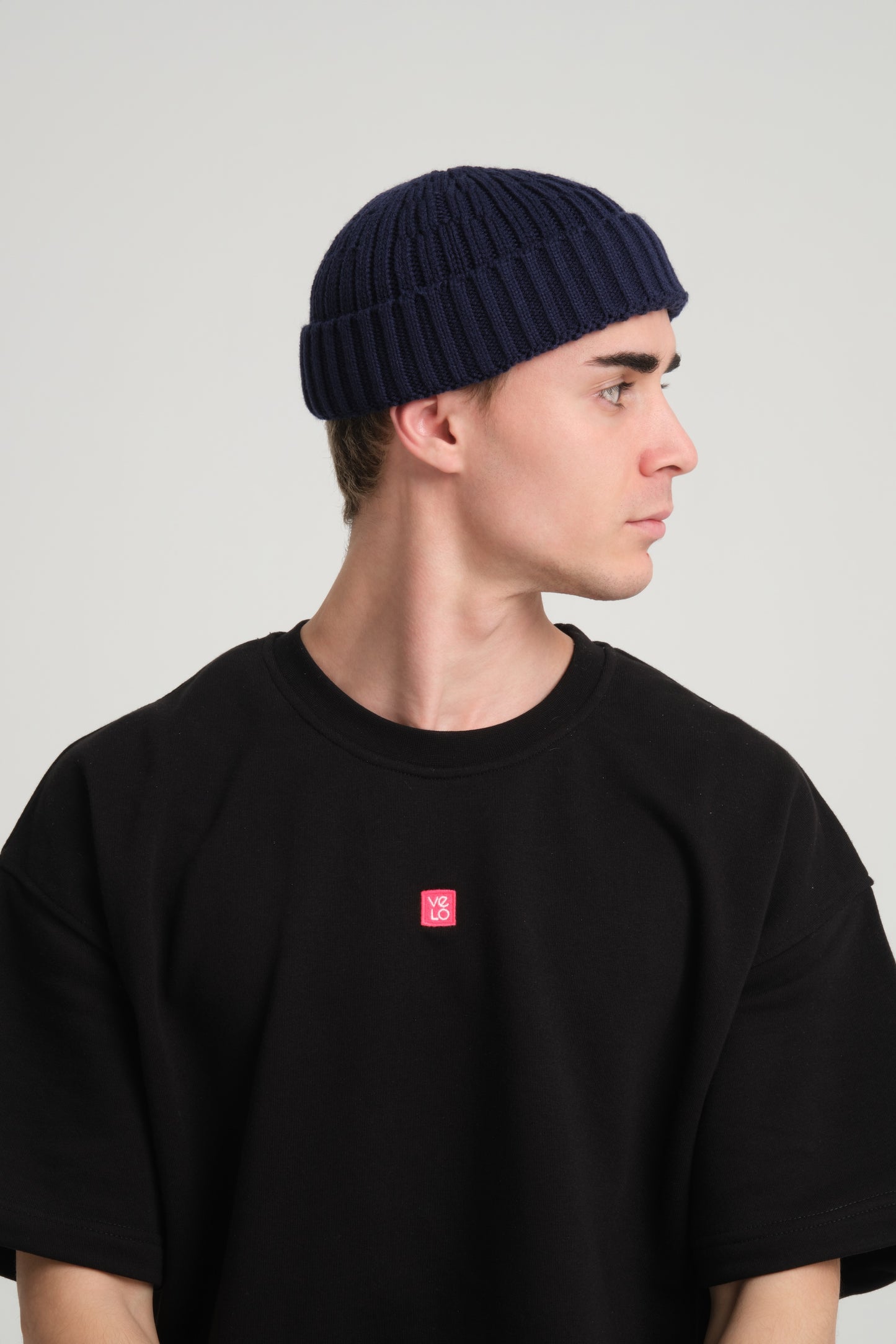 side view of a man wearing Navy Fisherman Beanie