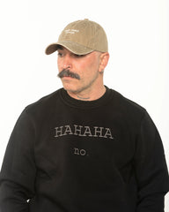 A man wearing the Need More Coffee Beige Washed Cap