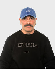 A man wearing the Need More Coffee Blue Washed Cap