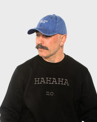 A man wearing the Need More Coffee Blue Washed Cap