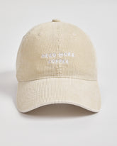 Cream cap with 'Need More Coffee' text on a light gray background