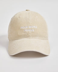 Cream cap with 'Need More Coffee' text on a light gray background