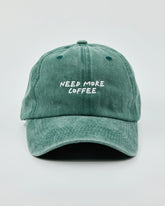 Front view of Need More Coffee Dark Green Washed Cap