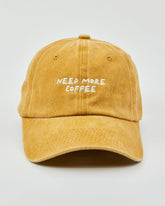 Front view of Need More Coffee Mustard Washed Cap