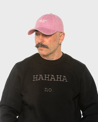 A man wearing the Need More Coffee Pink Washed Cap
