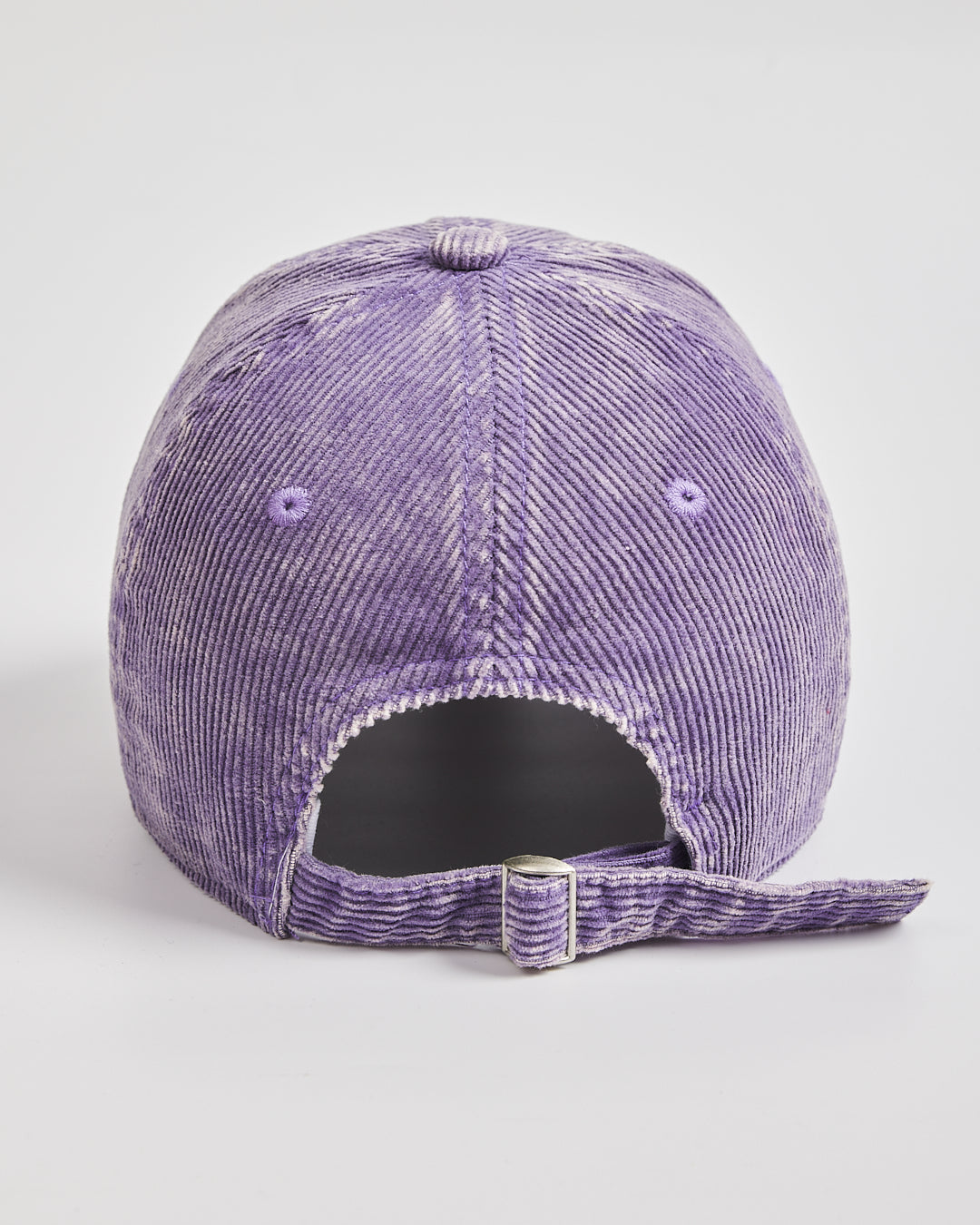 Purple corduroy cap on a light gray background