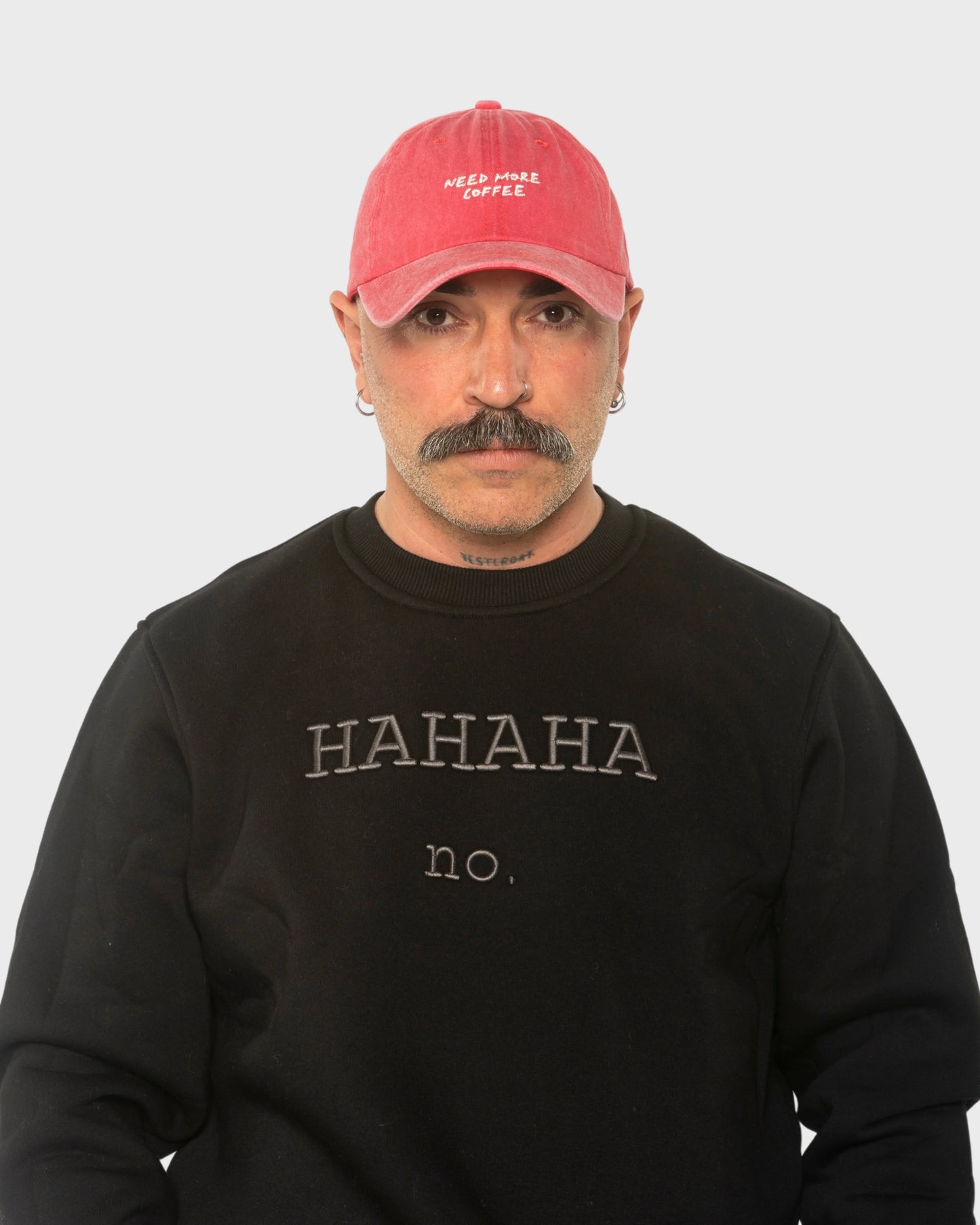 A man wearing the Need More Coffee Red Washed Cap