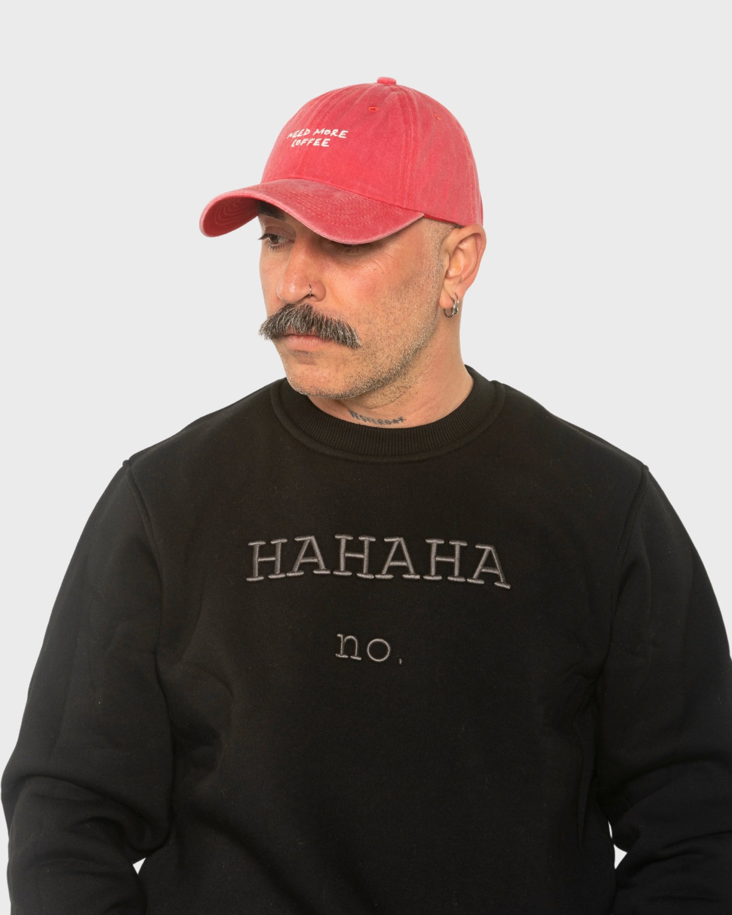 A man wearing the Need More Coffee Red Washed Cap