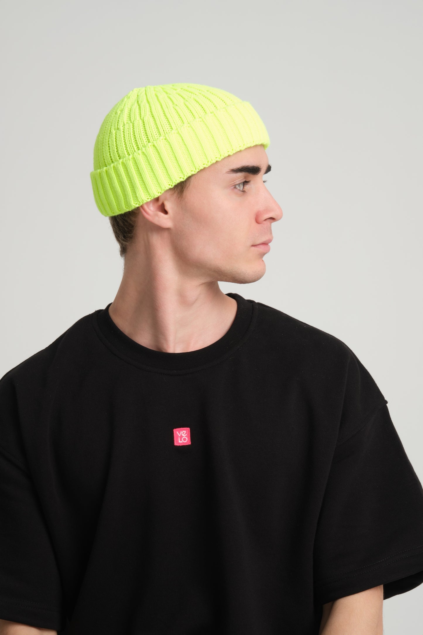 side view of a man wearing Neon Yellow Fisherman Beanie