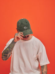 Person wearing a green cap with 'Not Today' text on an orange background
