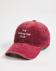 Red cap with 'The Notting Hill Club' text on a white background