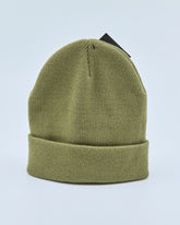 Olive green beanie on a light blue background