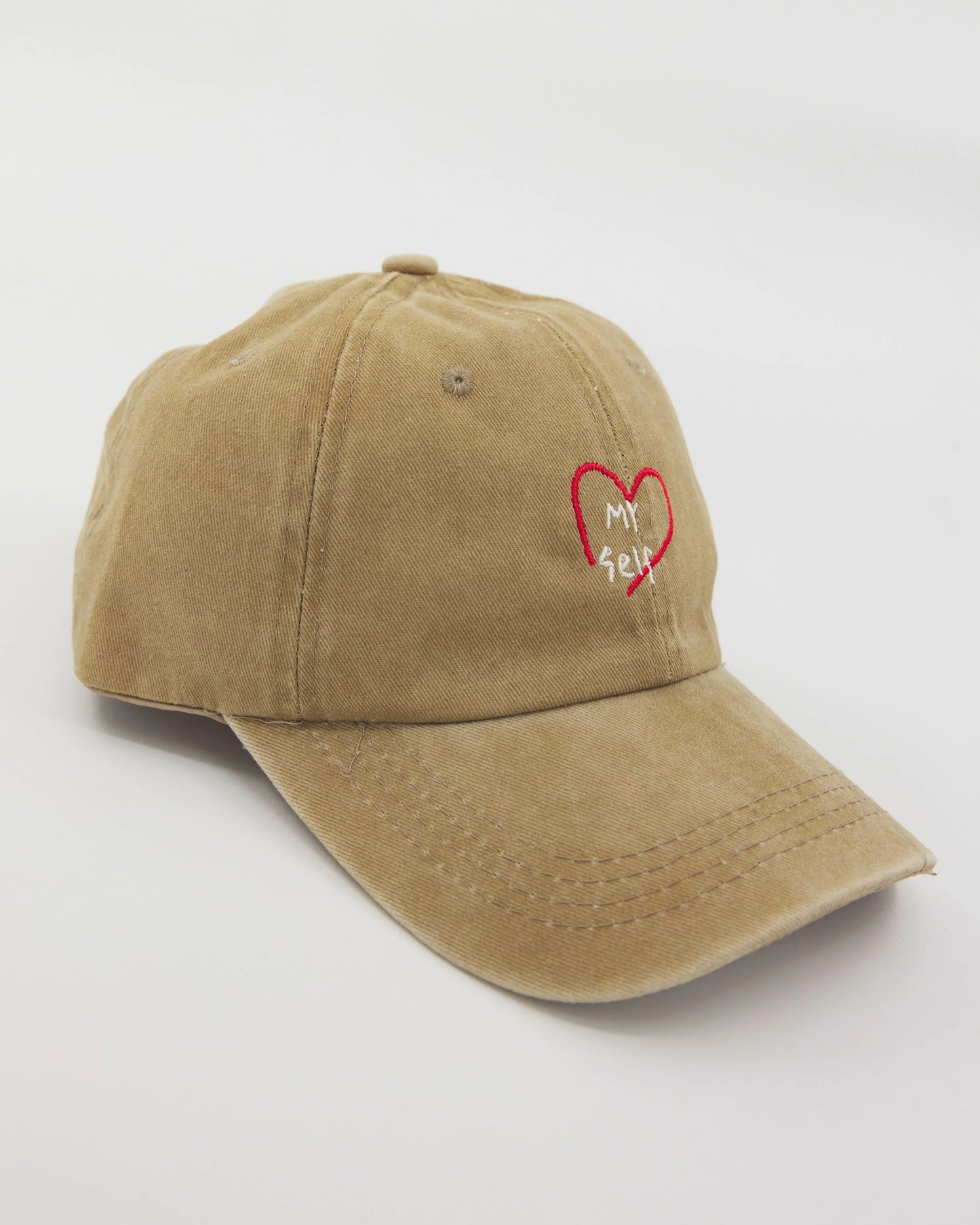 side view of olive green washed cap with love myself embroidered in white