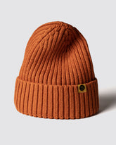 Orange knit beanie with a brand logo on a light gray background