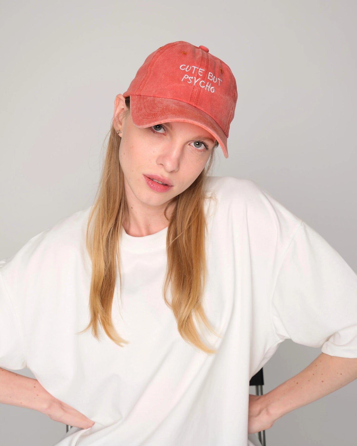 woman wearing Cute But Psycho Orange Washed Cap Hat